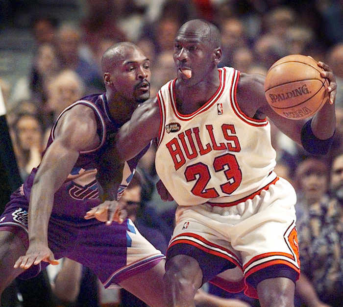 June 12, 1998; Chicago, IL, USA; Chicago Bulls guard Michael Jordan goes up against Utah Jazz player Bryon Russell in 1998 NBA Finals.